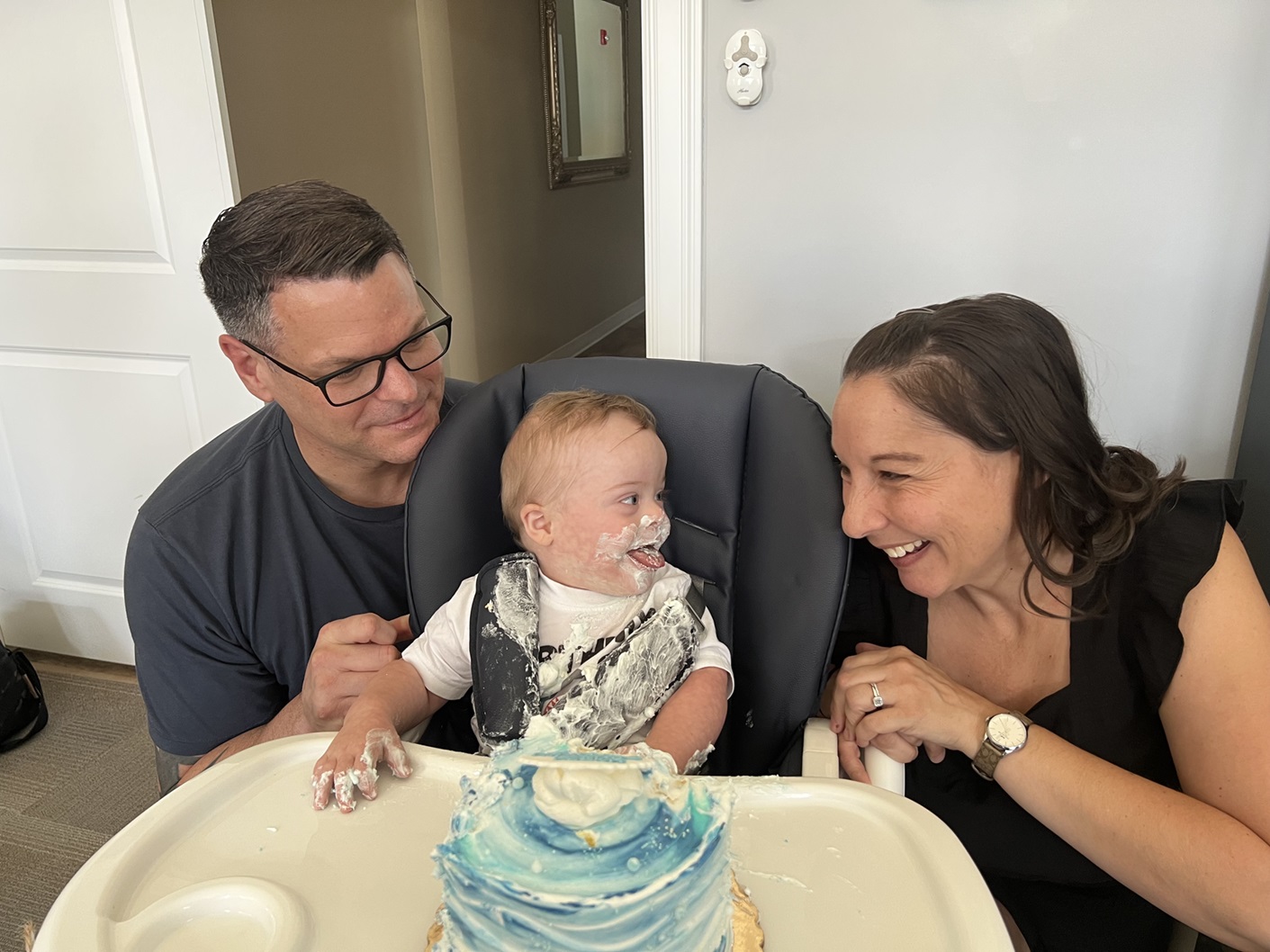 The Howe family celebrating Brody's first birthday with cake