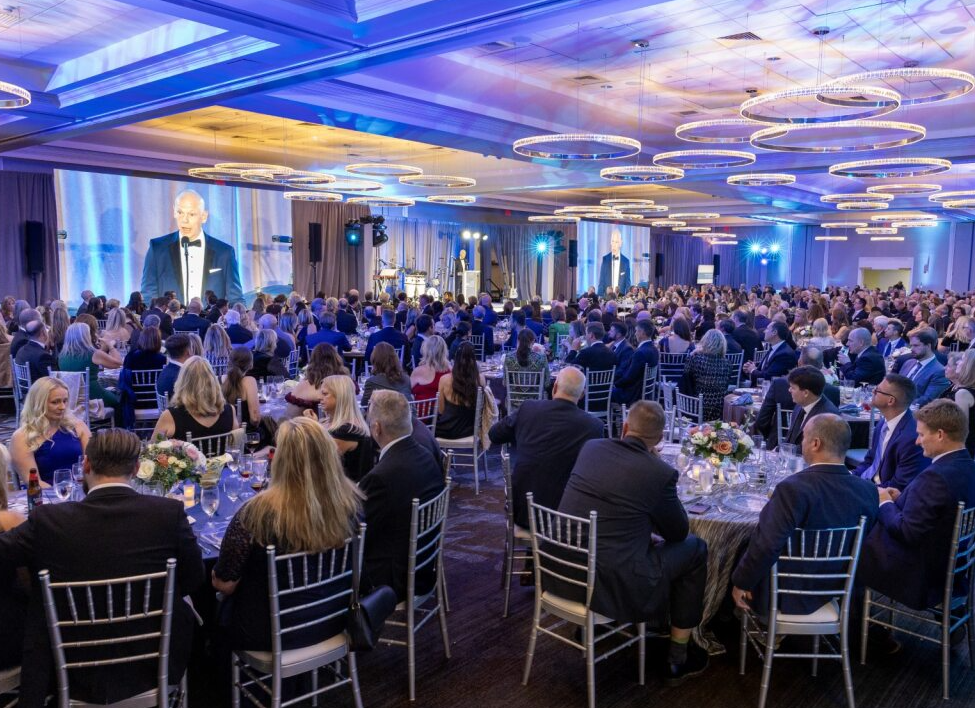 A photo of the ballroom at the 2025 South Shore Health Gala as Jason Tracy, MD speaks on stage.