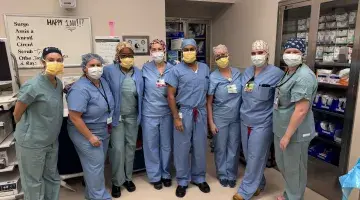 Neil Ghushe and members of his surgical team pose for a photo prior to his 1,000th bariatric surgery at South Shore Hospital.