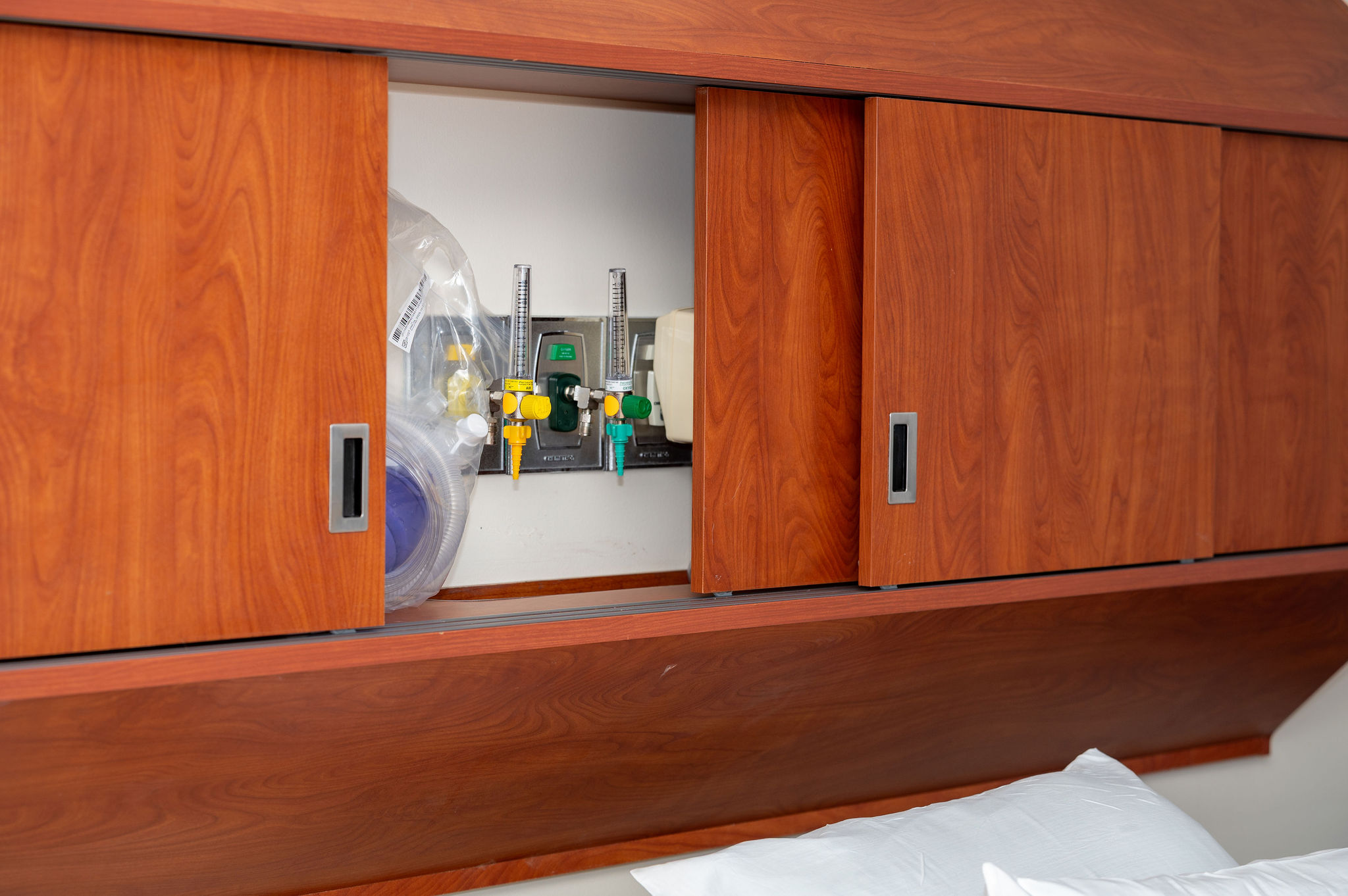 Wooden cabinets hiding medical equipment in a sensory informed care room at South Shore Hospital's pediatric unit