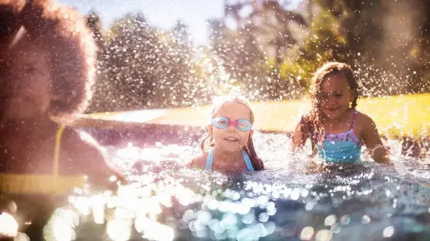 A group of young girls swimming in a pool