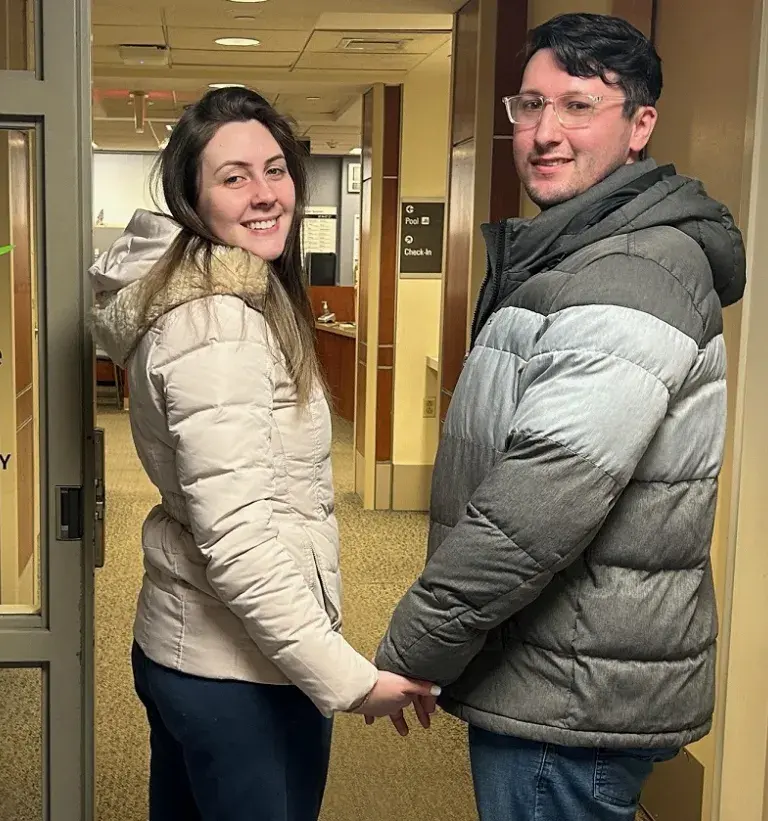 A woman and a man hold hands as they enter South Shore Health Physical Therapy and Wellness