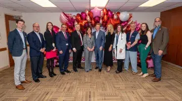 Group photo of representatives from Dunkin, joy in childhood, and south shore health
