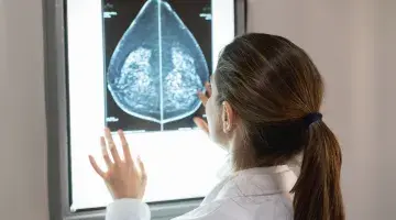 A provider looks at a mammogram scan on a screen
